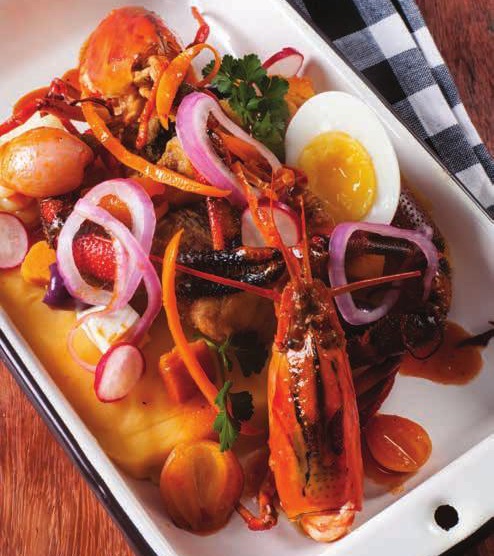 Causa Limeña con pescado frito, camarones escabechados y encurtido criollo