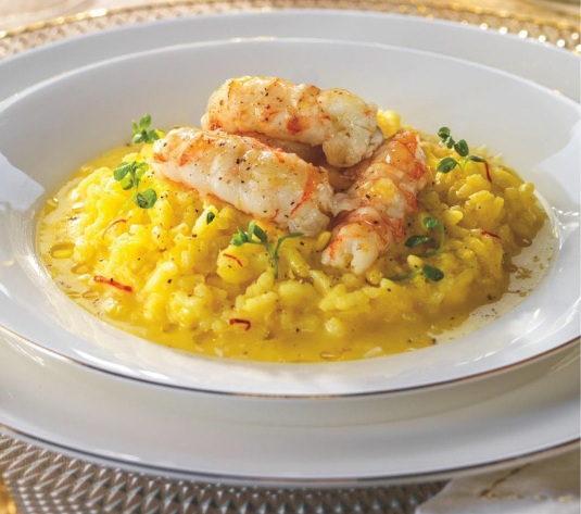 Cigalas a la plancha sobre risotto al azafrán